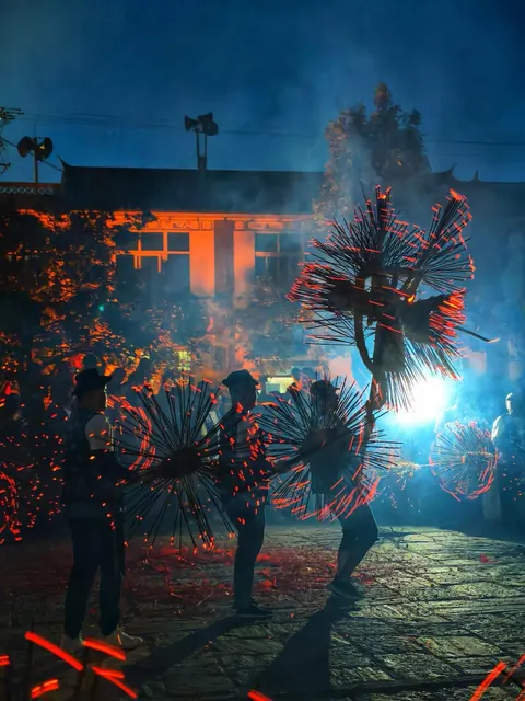 An incense-dragon dance at night during a village Benzhu festival