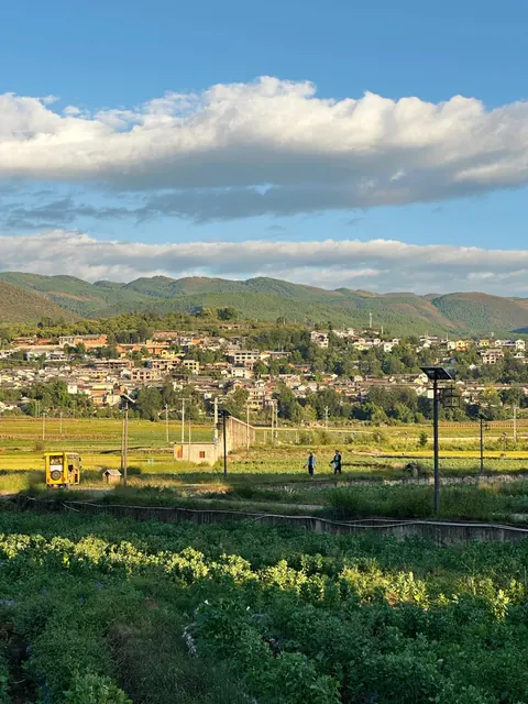 Fields and the village of Shaxi below the hills