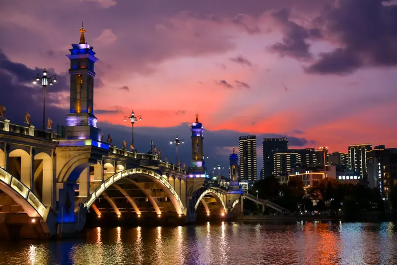 Xingsheng Bridge lit up at dusk under a pink sky